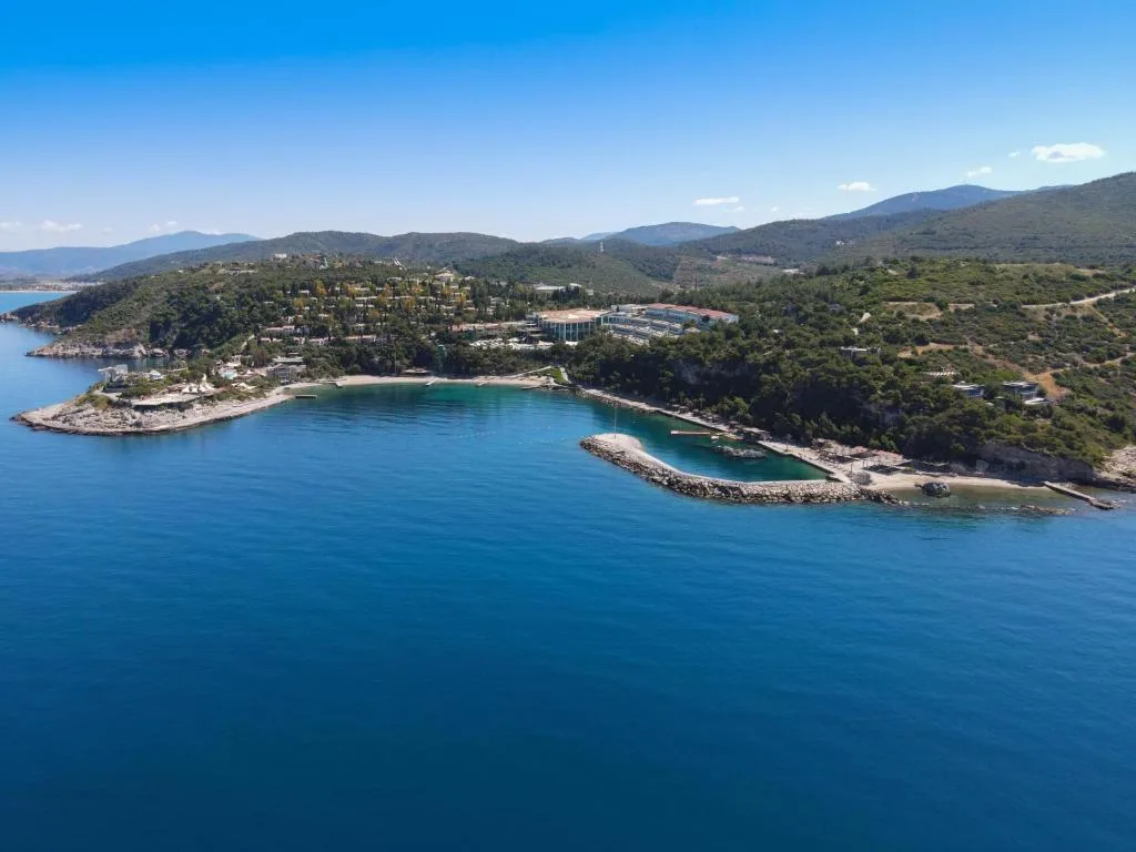Aerial view of Pine Bay Resort on its wooded peninsula in Kuşadası